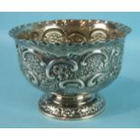 An Edwardian embossed rose bowl with crimped border, on circular foliate foot, by Goldsmiths &