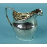 A Late-George-III oval cream jug with reeded border and handle and engraved body, 9cm high, London