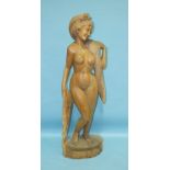 A Thai carved wood figure of a naked young woman with long flowing hair, standing on a plinth, 154cm