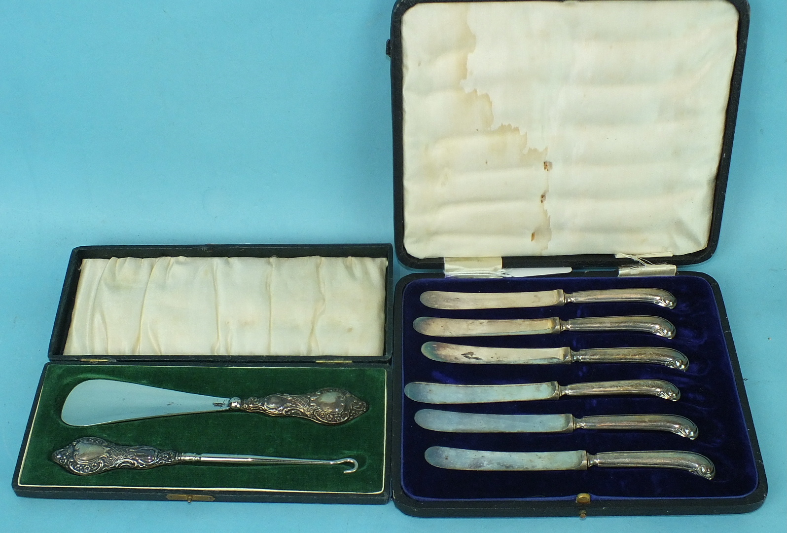 A cased silver-handled button hook and shoe horn, Chester 1914 and a cased set of silver pistol-