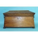 An early-19th century rosewood sarcophagus-shaped three-division tea caddy on bun feet, with