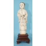 A 19th century Chinese ivory figure of a standing lady in long robes, on hardwood stand, 22cm high.