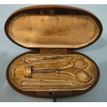 A 19th century Continental etui, the oval burr wood and mother-of-pearl-inlaid case containing