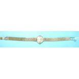 Roamer, a ladies 9ct gold wrist watch with circular dial and integral textured brick-link