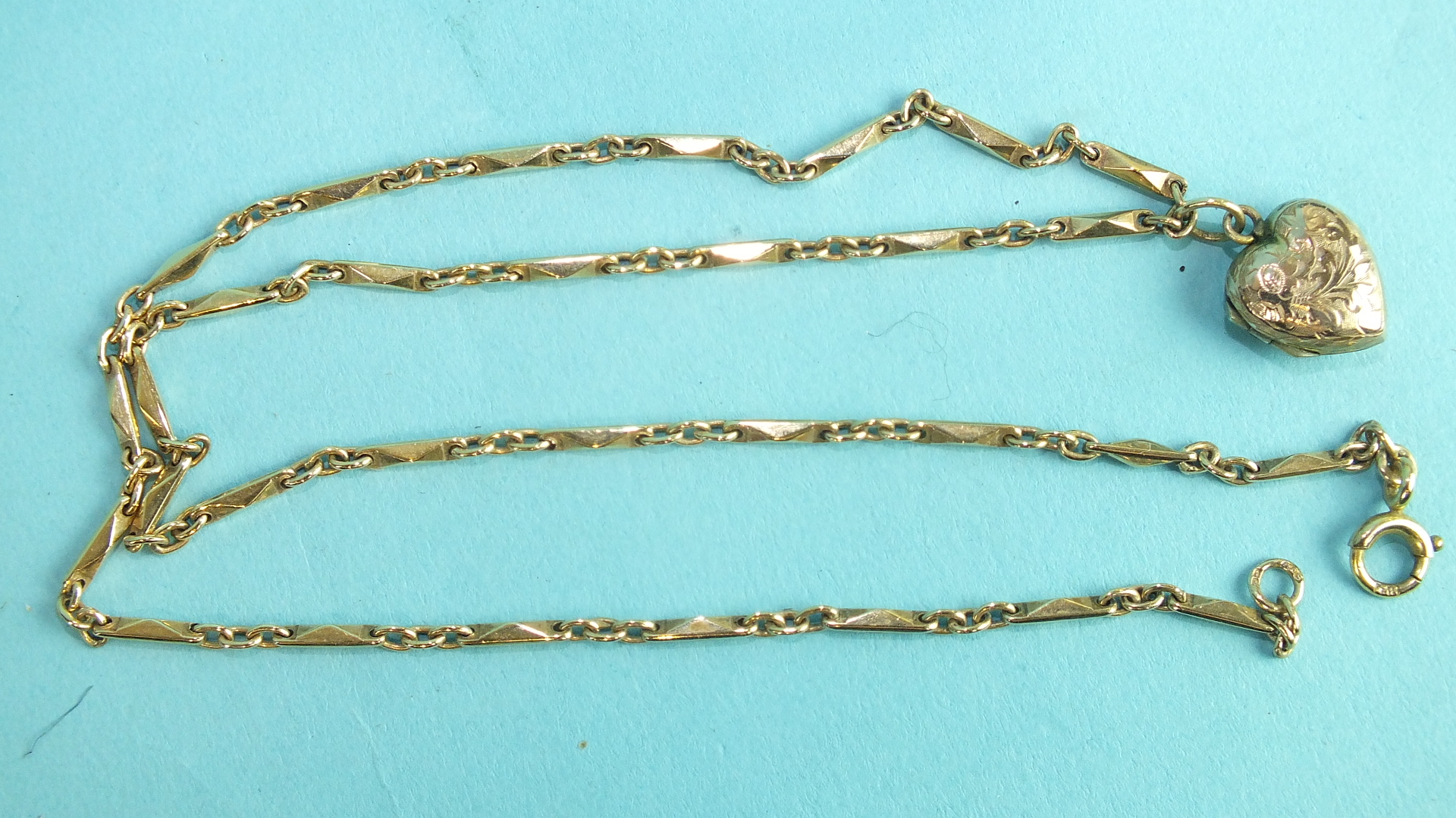 A 9ct gold fancy-link neck chain with heart-shaped locket, 45cm long, 11g.