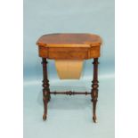 A Victorian walnut workbox and writing desk, the lift lid revealing a writing surface above a fitted