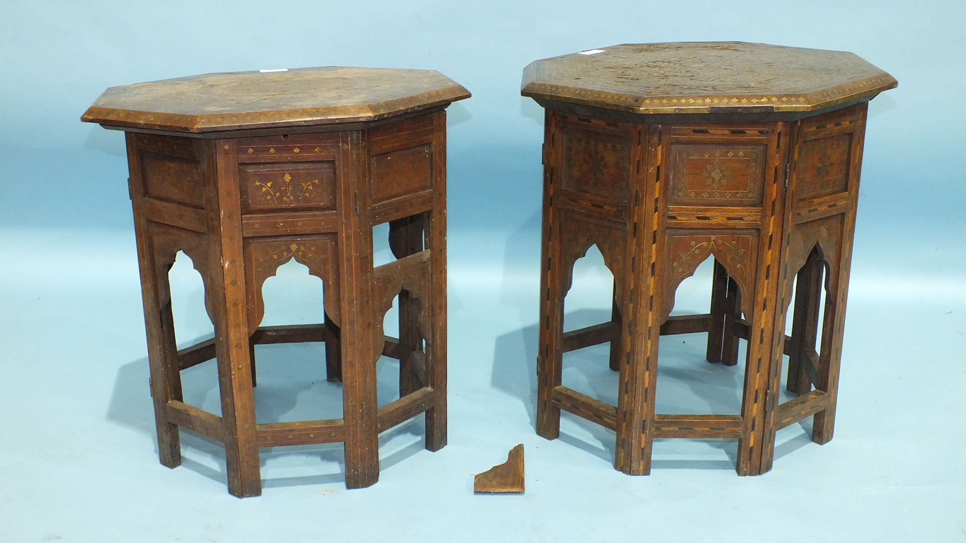 Two octagonal brass inlay hardwood occasional tables with hinged folding stands, (some inlay