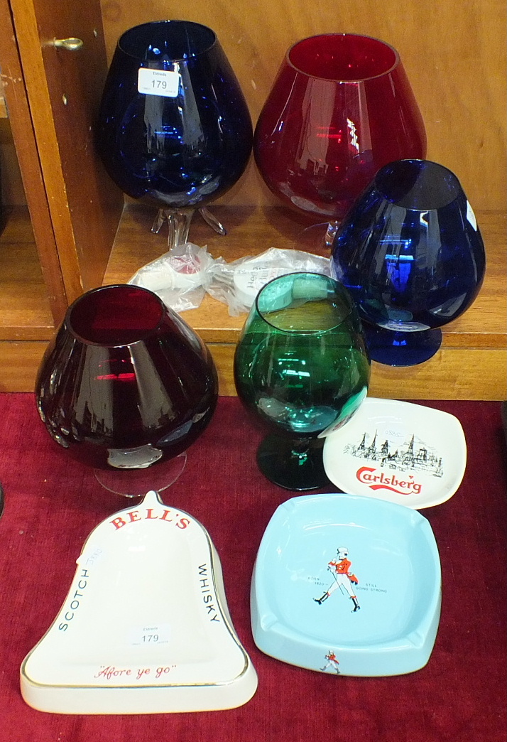 Three Wade PM advertising ashtrays, coloured glass brandy glasses, etc.