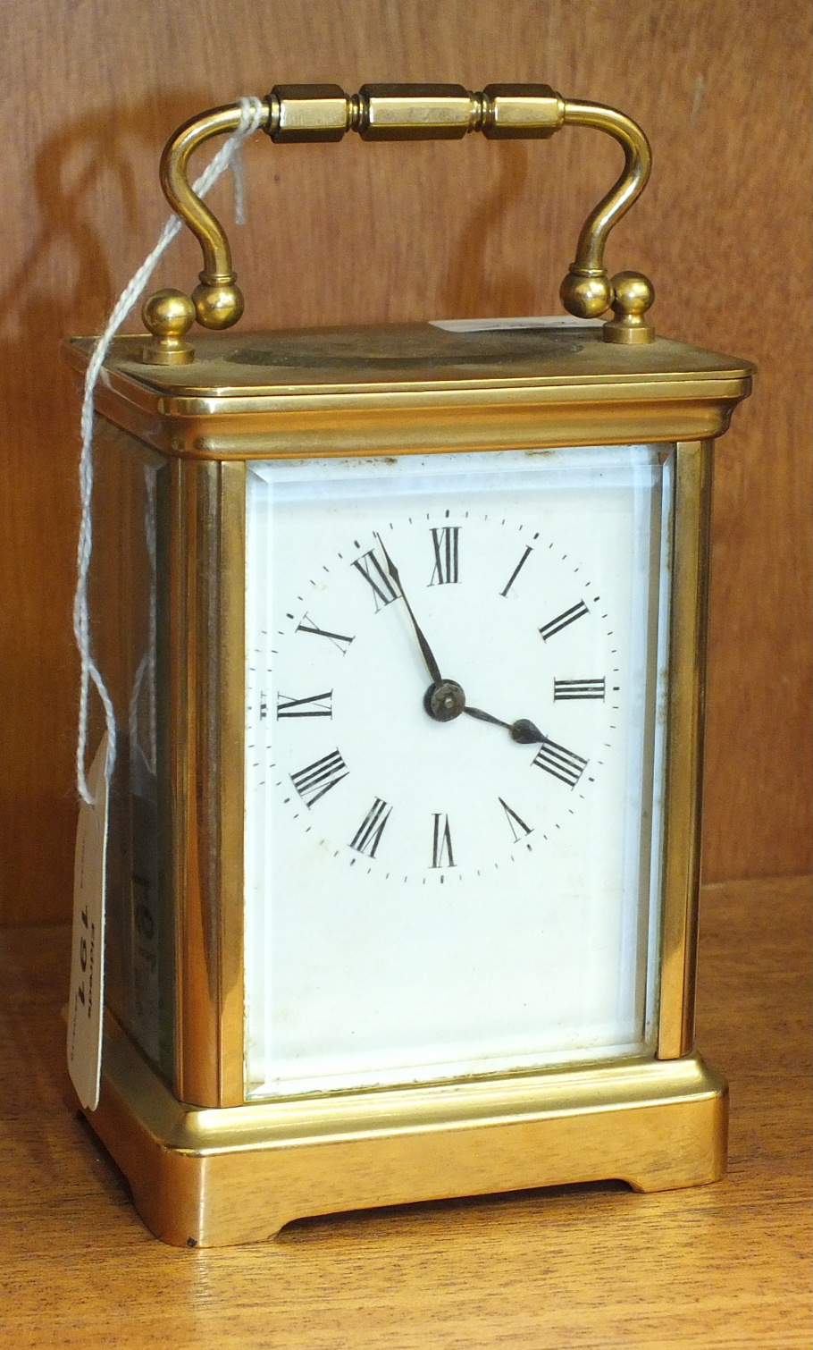 A brass case carriage timepiece with carrying handle, 14cm high.