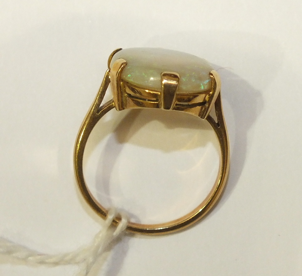A dress ring claw-set a water opal, in 9ct yellow gold mount, size R, 5.2g. - Image 2 of 5
