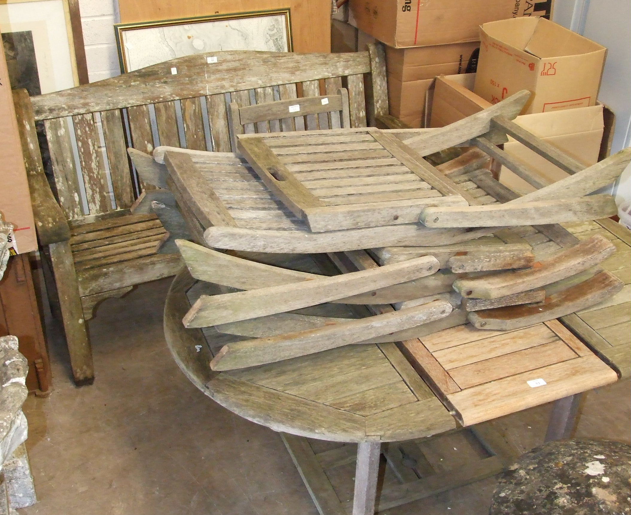 A teak garden bench, 156cm, a similar extending table and four folding chairs, (6).