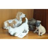 A collection of four Royal Copenhagen dog figures, including 'Dachshund Puppy' No.1407, 'Bassett