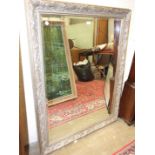 A large modern framed bevelled wall mirror, 135 x 108cm overall.