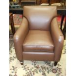 A modern leatherette armchair with loose cushion.