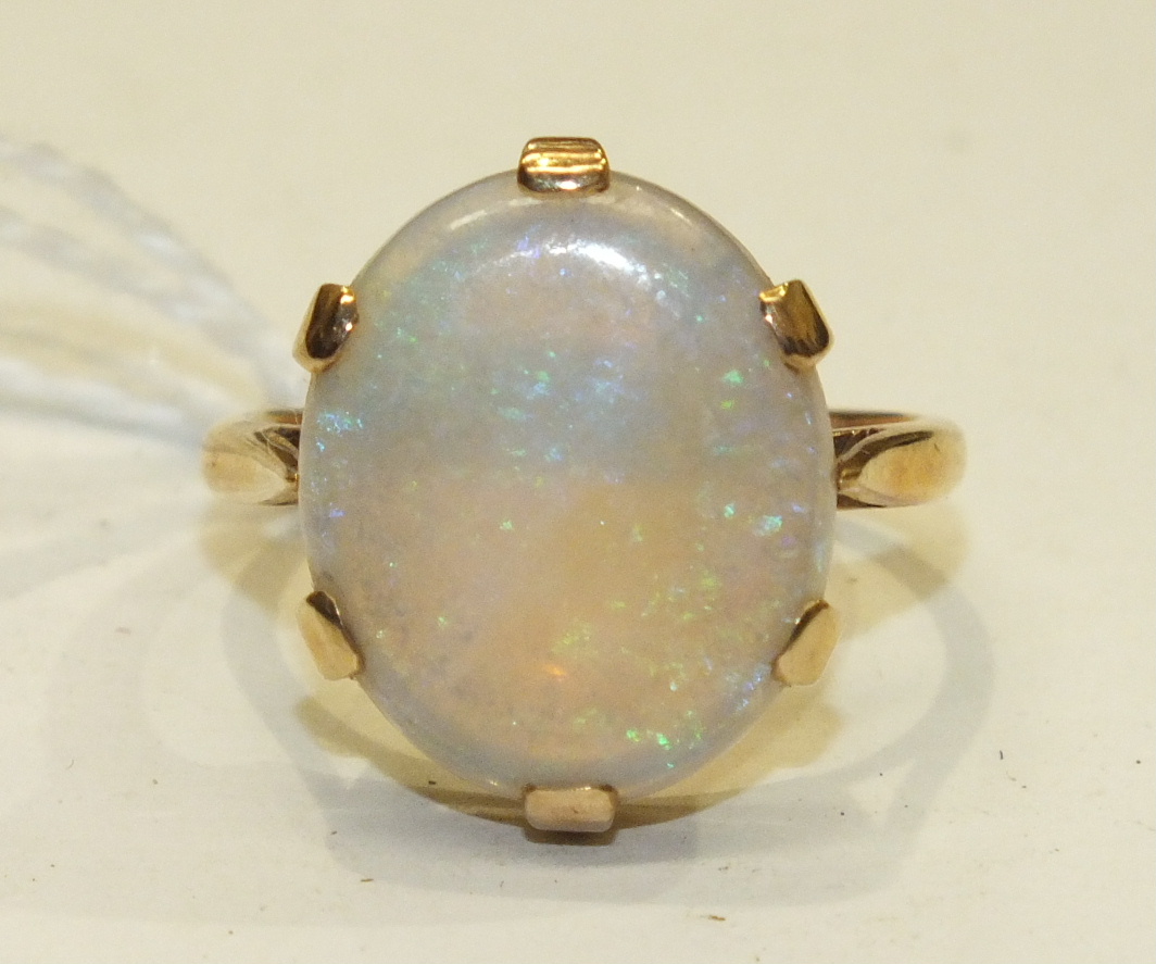 A dress ring claw-set a water opal, in 9ct yellow gold mount, size R, 5.2g.