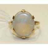 A dress ring claw-set a water opal, in 9ct yellow gold mount, size R, 5.2g.