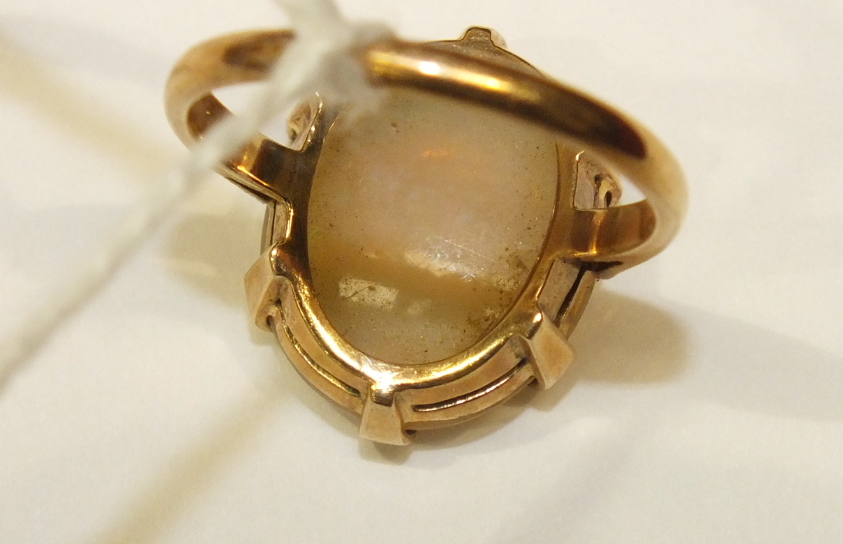 A dress ring claw-set a water opal, in 9ct yellow gold mount, size R, 5.2g. - Image 4 of 5