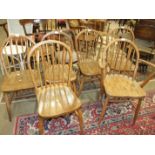 A set of four stained elm and beech hoop-back chairs and two other stick-back chairs, (6).