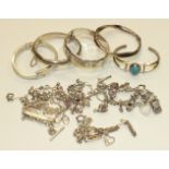 Four silver hinged bangles and other bracelets, charms, etc, 214g.