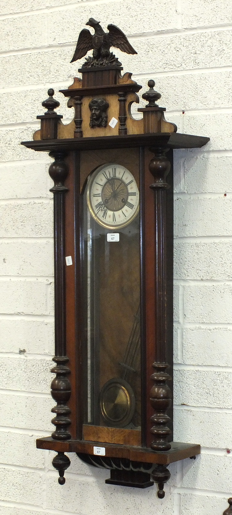 A late-19th century Vienna-style wall clock, the enamel dial with Roman numerals.