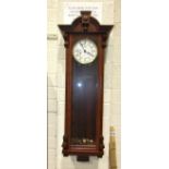 A modern mahogany finish Vienna-type wall clock with gong-striking movement, enamel dial with