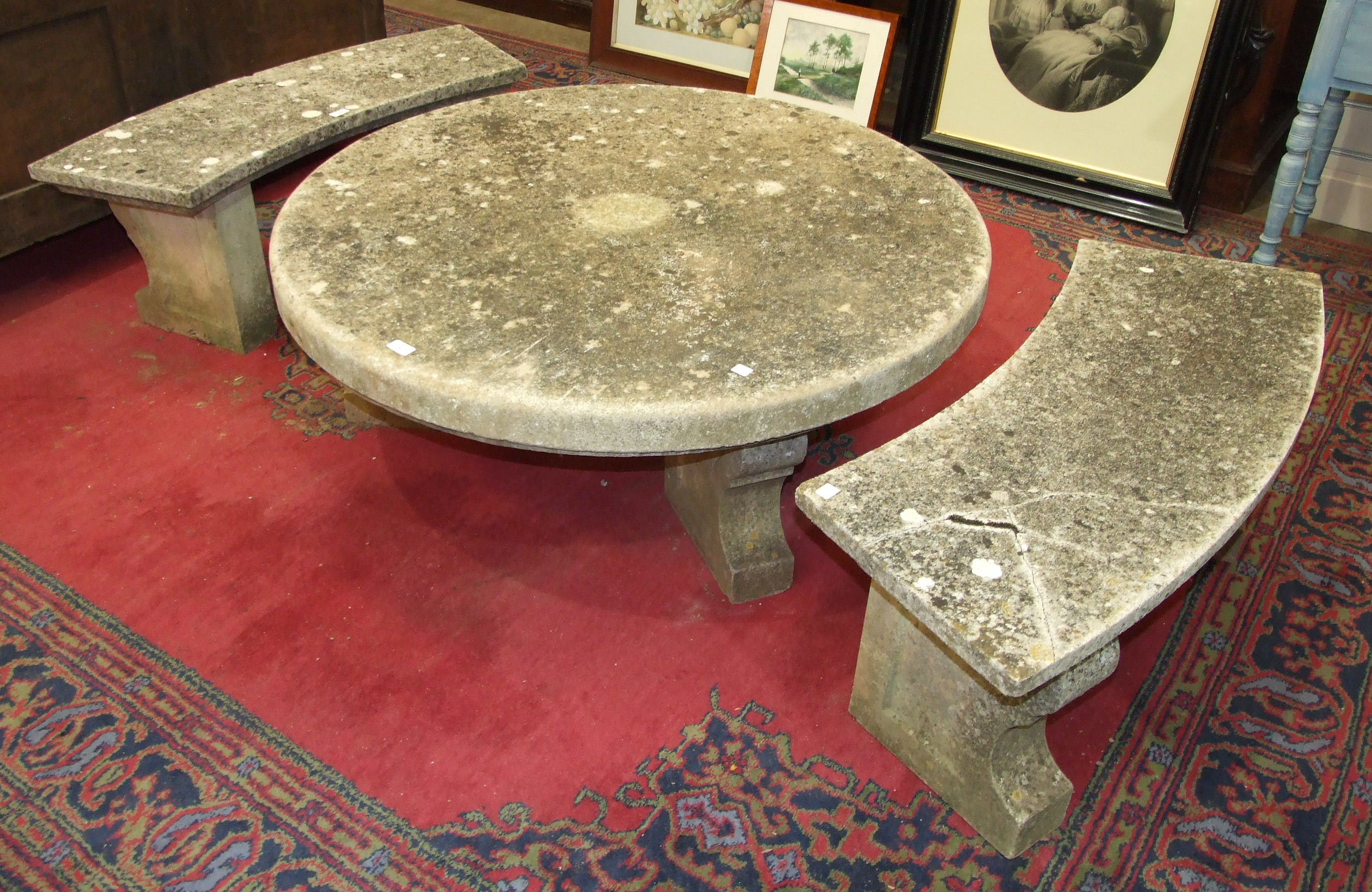 A minster stone circular low garden table, 116cm diameter, together with two minster stone curved