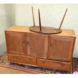 An Ercol medium elm sideboard, the rectangular top above three cupboard doors and two drawers, 129cm