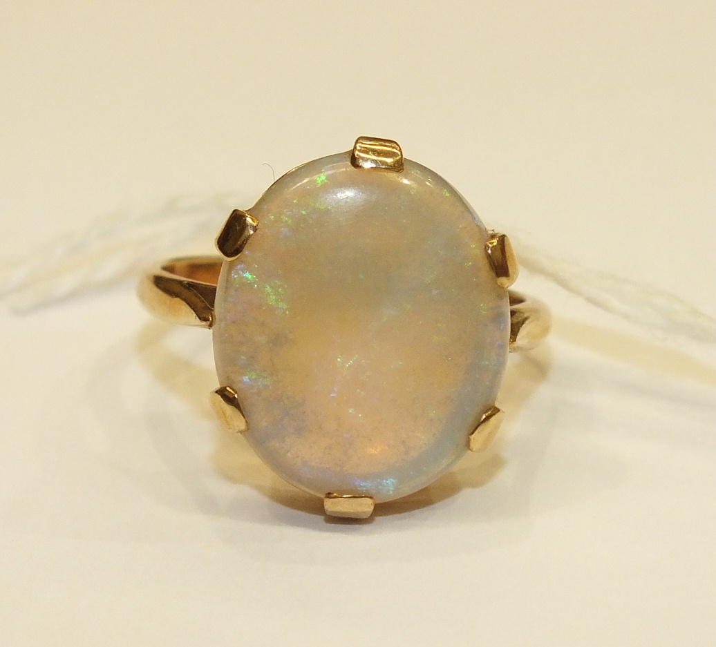 A dress ring claw-set a water opal, in 9ct yellow gold mount, size R, 5.2g. - Image 5 of 5