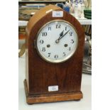 A mahogany mantel clock of arch form with gong-striking movement, 36cm high.