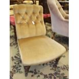 An Edwardian upholstered button-back nursing chair on turned front legs.
