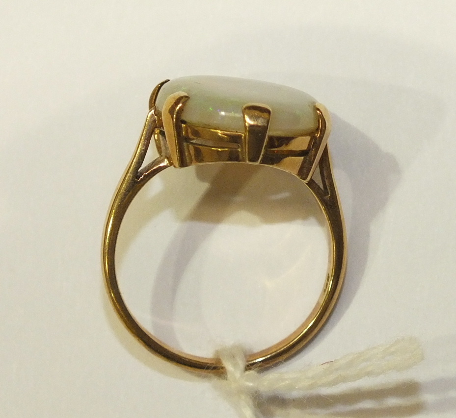 A dress ring claw-set a water opal, in 9ct yellow gold mount, size R, 5.2g. - Image 3 of 5