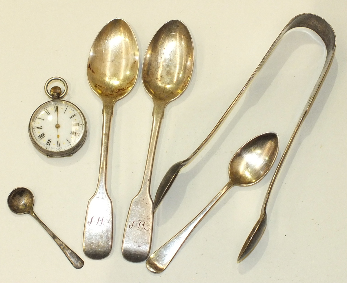 A pair of silver Exeter sugar tongs, a .800 fob watch and four other silver spoons.