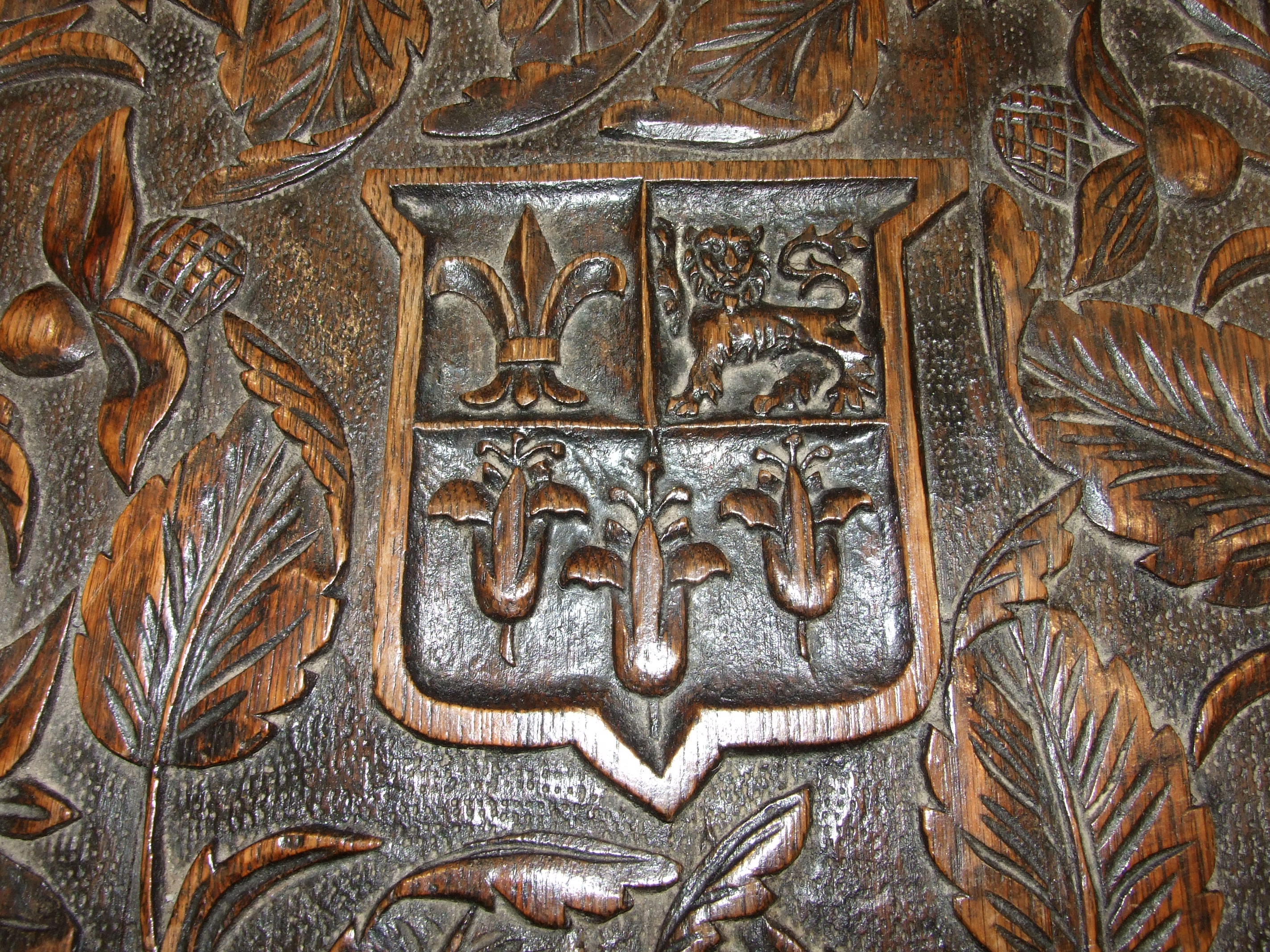 An oak two-tier occasional table carved with flowers and Eton School coat of arms and motto - Image 3 of 3