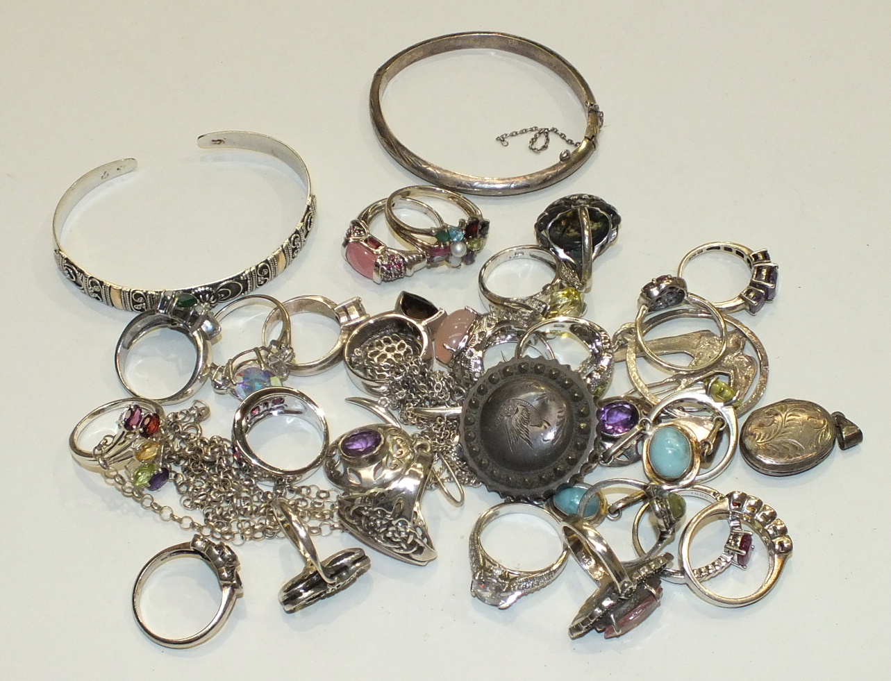 A quantity of gem-set silver rings, two silver bangles and other items, 174g.