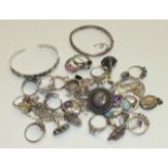 A quantity of gem-set silver rings, two silver bangles and other items, 174g.