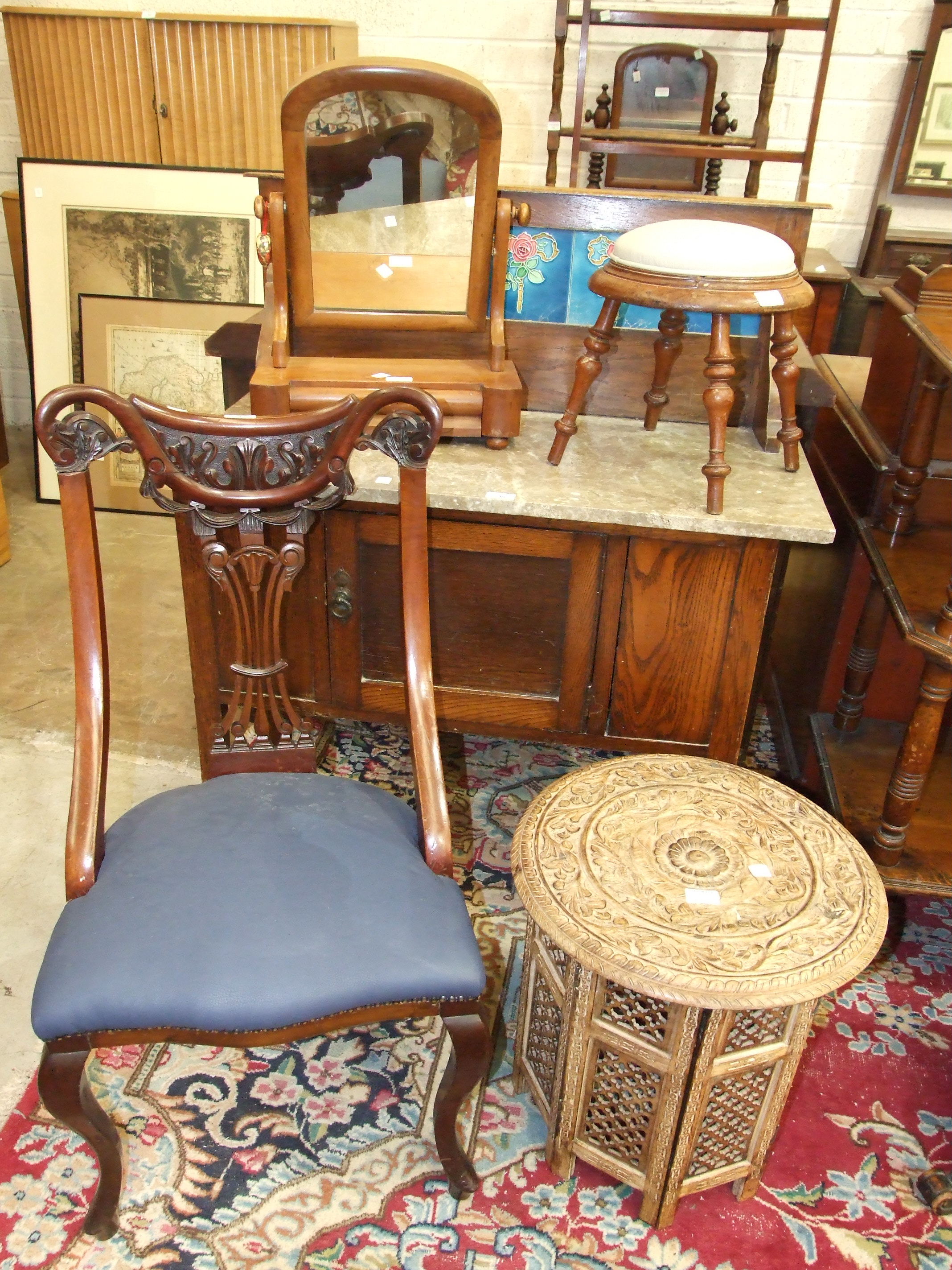 A marble-top tiled back washstand, a carved circular occasional table, a mahogany nursery chair