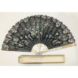 A 19th century fan with mother-of-pearl guards, (repaired) and sticks and painted black gauze leaf