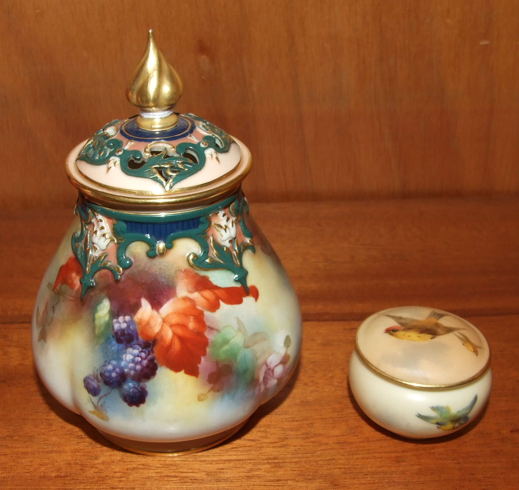 A Royal Worcester ovoid quatre-lobed pot pourri vase and cover painted with blackberries, leaves and
