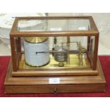 A mahogany-cased barograph, the base fitted with a drawer containing cards, 37cm wide.