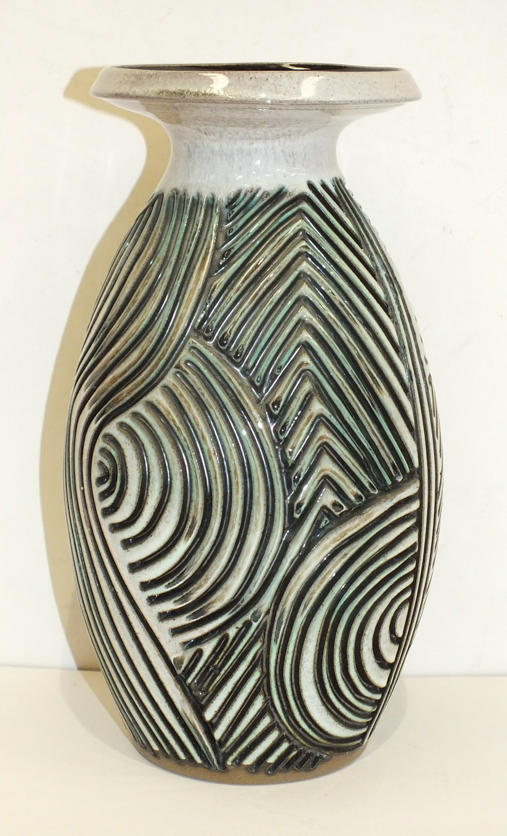 A Poole Pottery Atlantis vase by Jenny Haigh, of ovoid form with flared rim, the body with incised