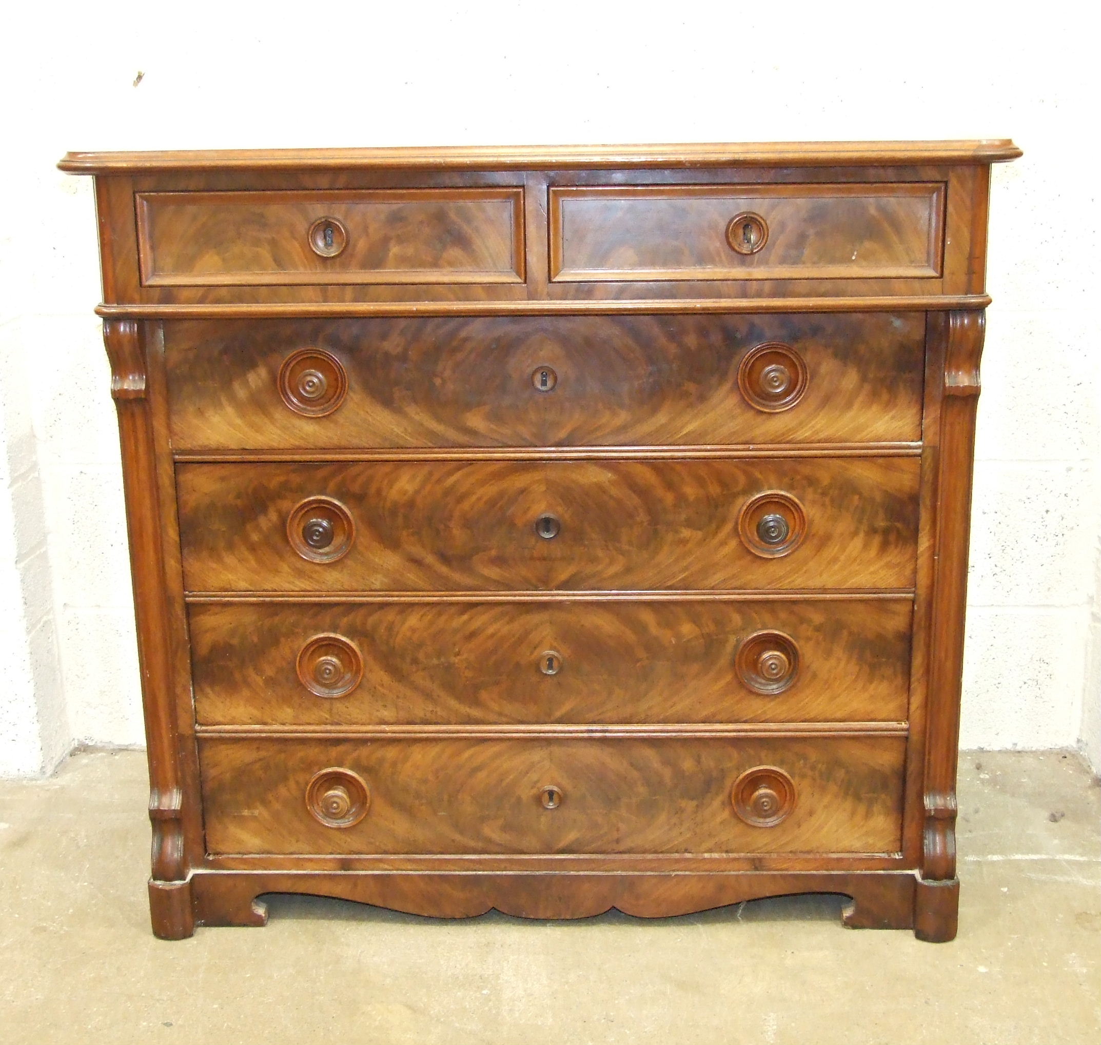 A 19th century Continental mahogany chest of two short and four long graduated drawers, on cut-