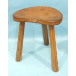 A Robert 'Mouseman' Thompson of Kilburn oak stool with dished kidney-shaped seat, raised on three