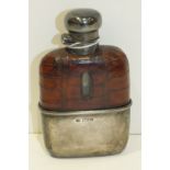 A George V silver whisky flask with silver twist lid and cup on glass flask, with leather jacket