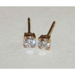 A pair of diamond ear studs, each 0.15cts approximately, in unmarked gold mounts, 0.7g.