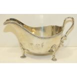 A Walker & Hall silver sauce boat with beaded rim, on three shell feet, Sheffield 1940, ___4½oz.