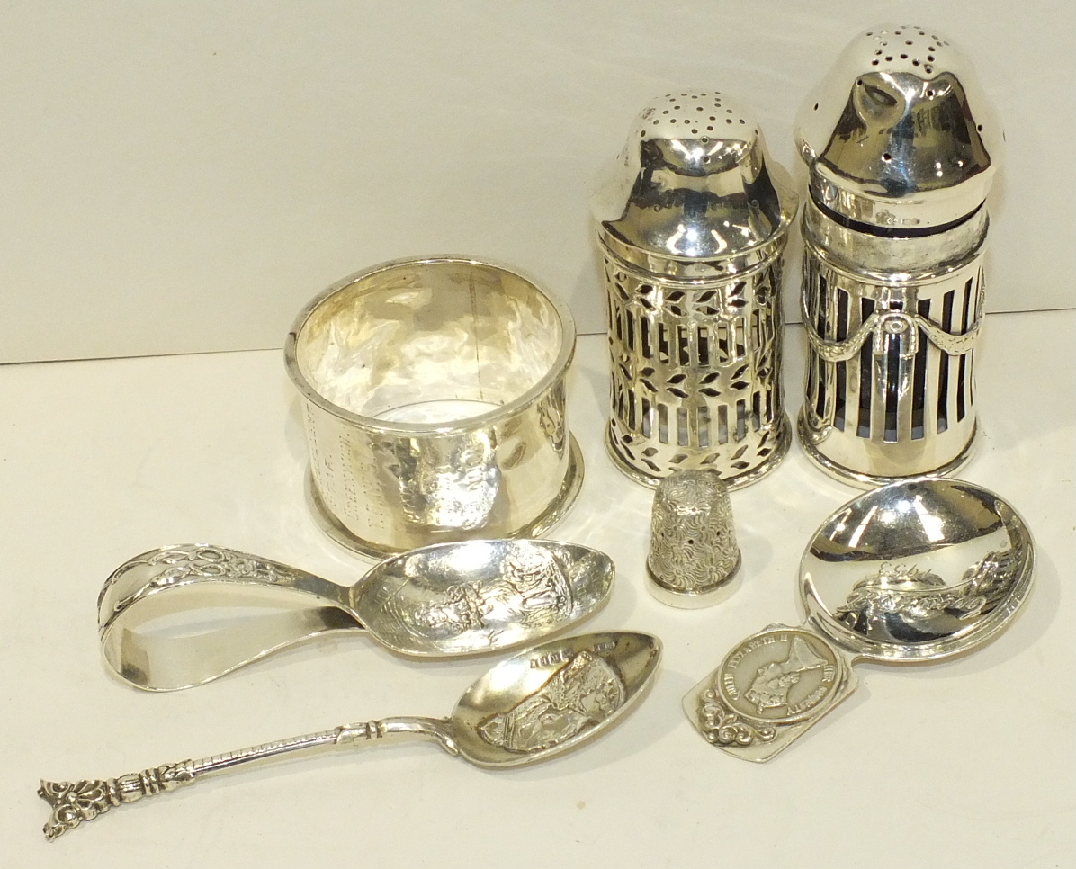 Two silver pierced pepper pots, a silver napkin ring, a baby's feeder spoon and other small