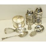 Two silver pierced pepper pots, a silver napkin ring, a baby's feeder spoon and other small