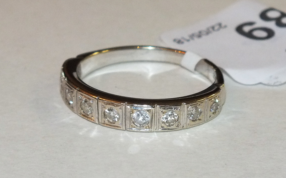 An 18ct yellow and white gold half-eternity ring set nine brilliant-cut diamonds, size R½, 4g.