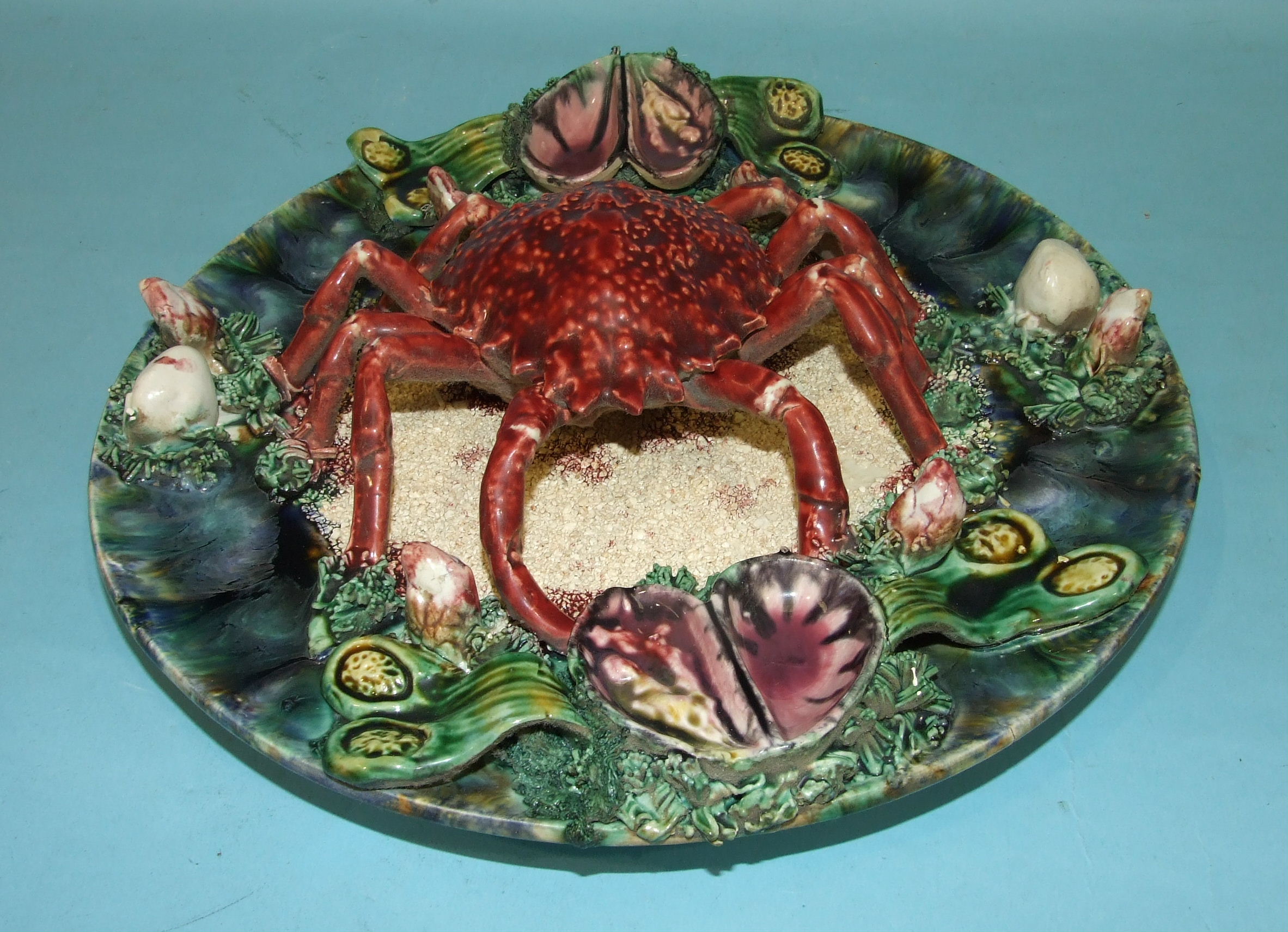 A Portuguese Palissy Ware dish decorated in relief with a spider crab, mussels and other