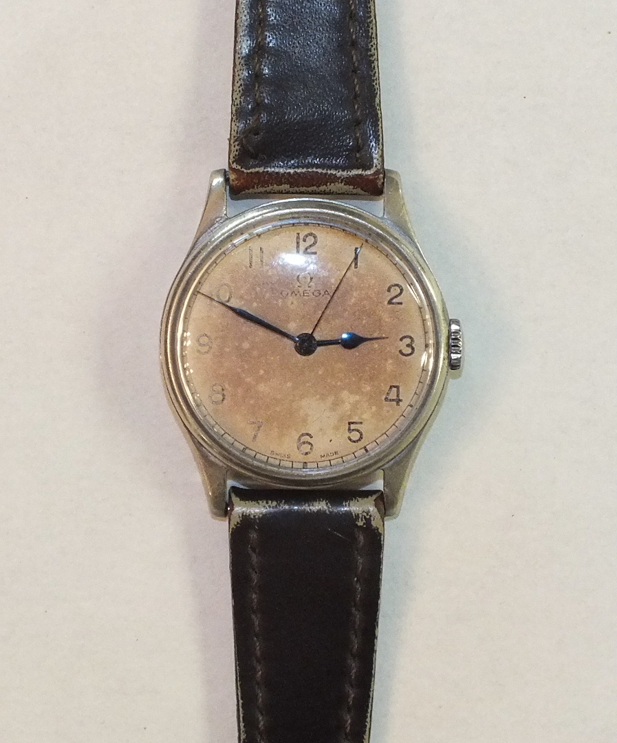 Omega, a WWII military wrist watch Calibre 30T2, the cream dial, (discoloured), with Arabic numerals